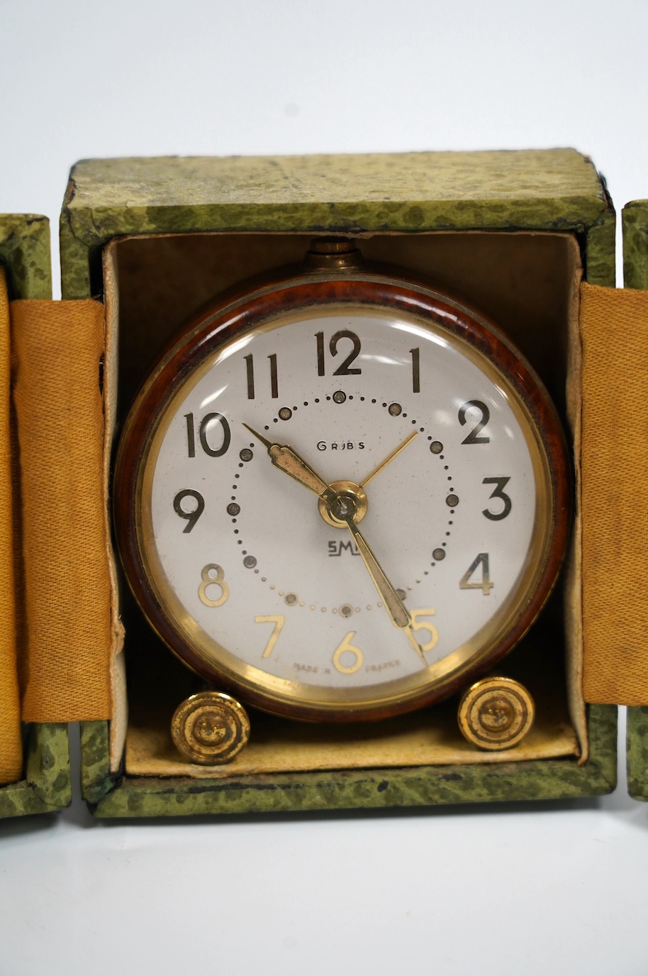 An Art Deco boxed SML enamelled alarm clock, 5.2cm diameter face. Condition - fair